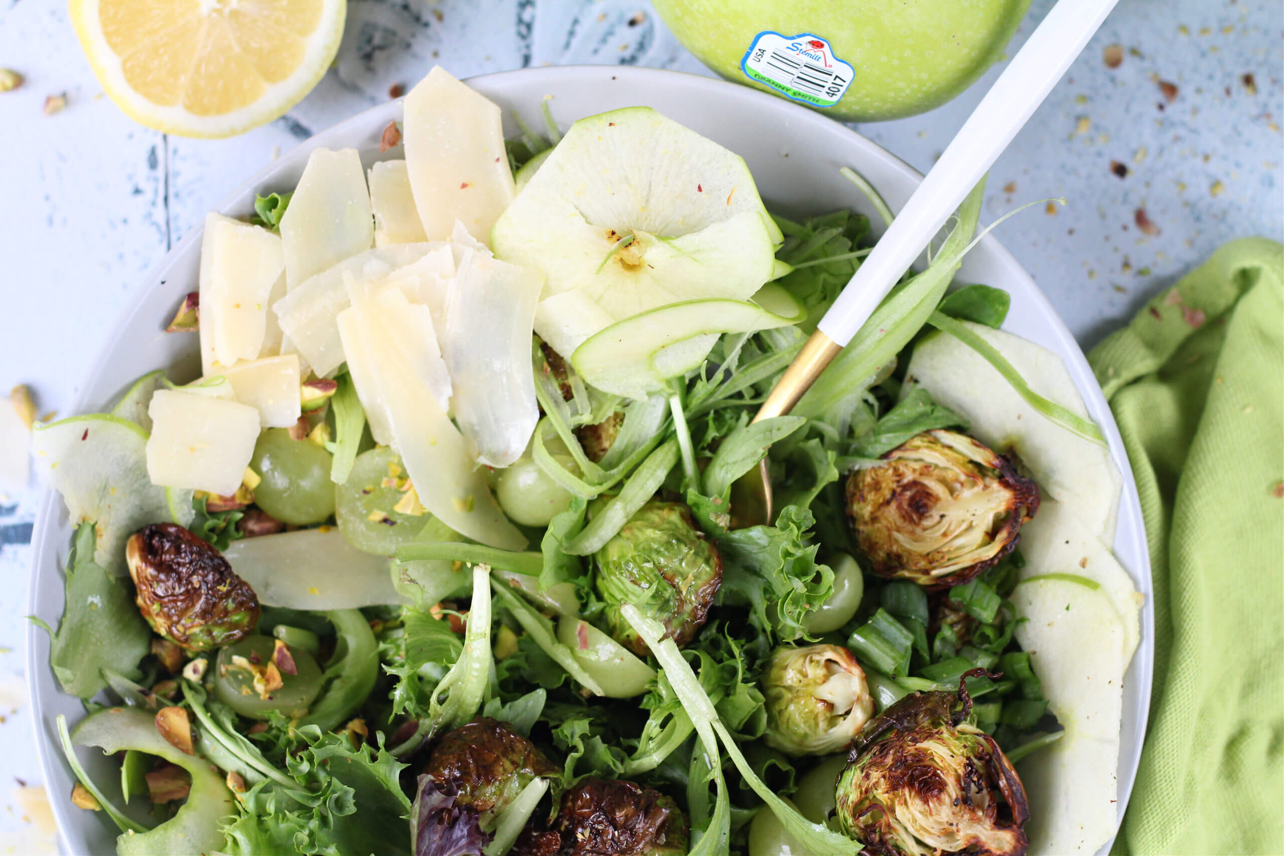 The Ultimate Green Salad plated with air fried brussel sprouts