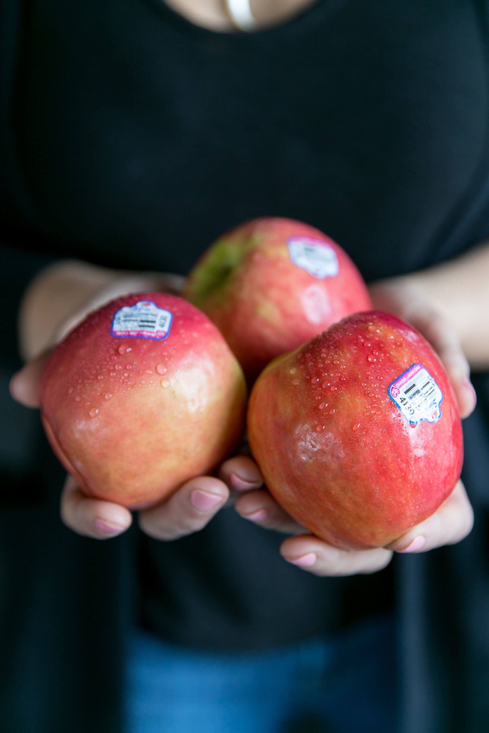 Pink Lady apples in someone's hands
