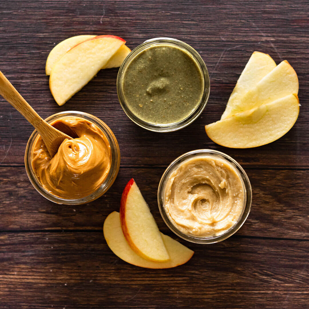 peanut, almond, and pistachio butter with apple slices