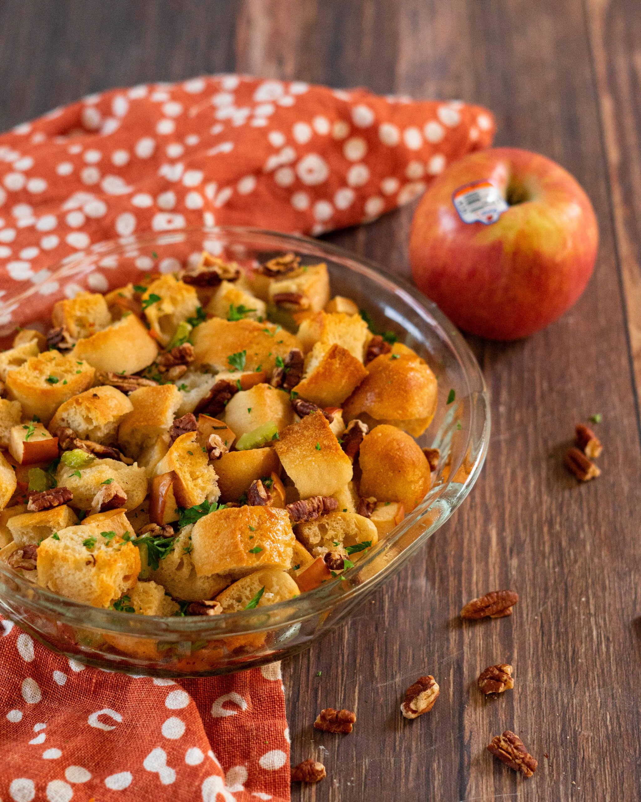 Apple Pecan stuffing on a countertop with an apple in the background