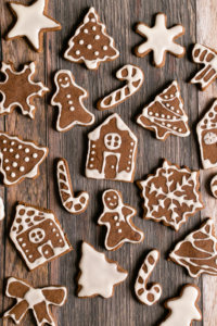 An overview of the gingerbread apple cookies in tree, house, and candy cane shapes