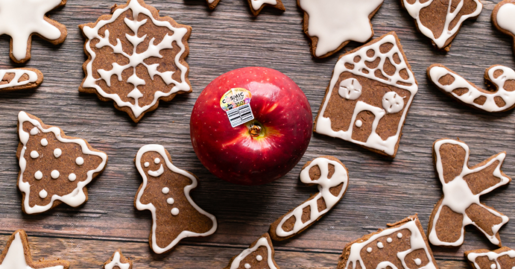 From above, a red apple with frosted gingerbread apple cookies around the centered apple