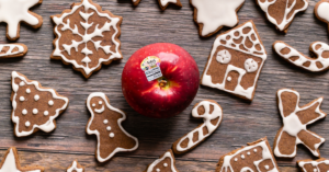 From above, a red apple with frosted gingerbread apple cookies around the centered apple