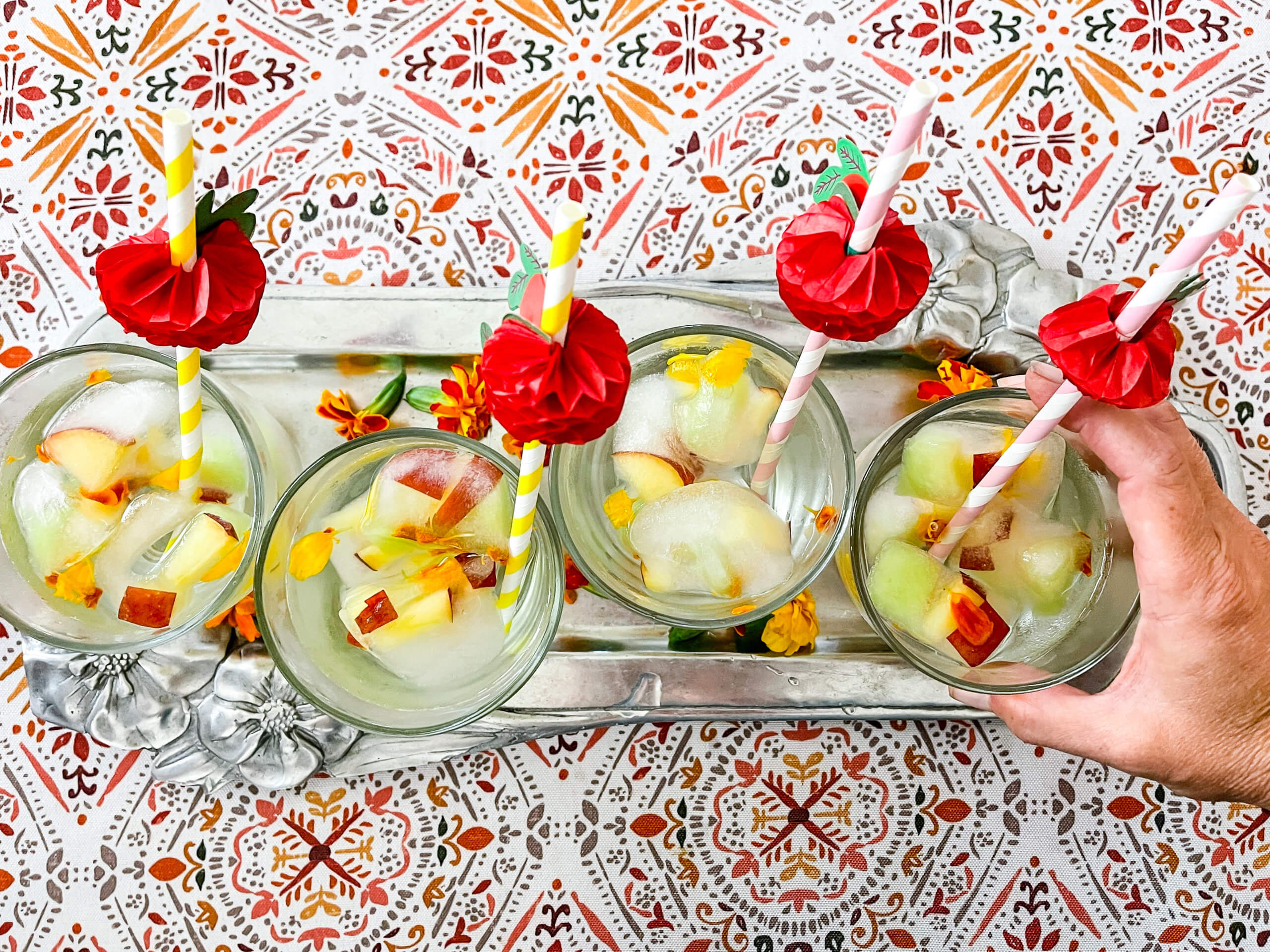 A tray of glasses with water and a Tropic Refresher ice cube.