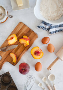 portrait overhead flat lay with peaches on cutting board)