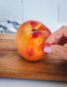 peach skin being removed from fruit