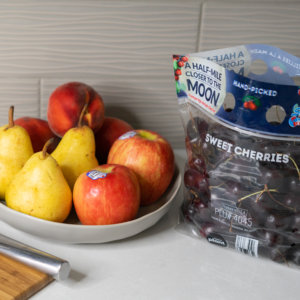 pear, apple, and cherries on the kitchen counter