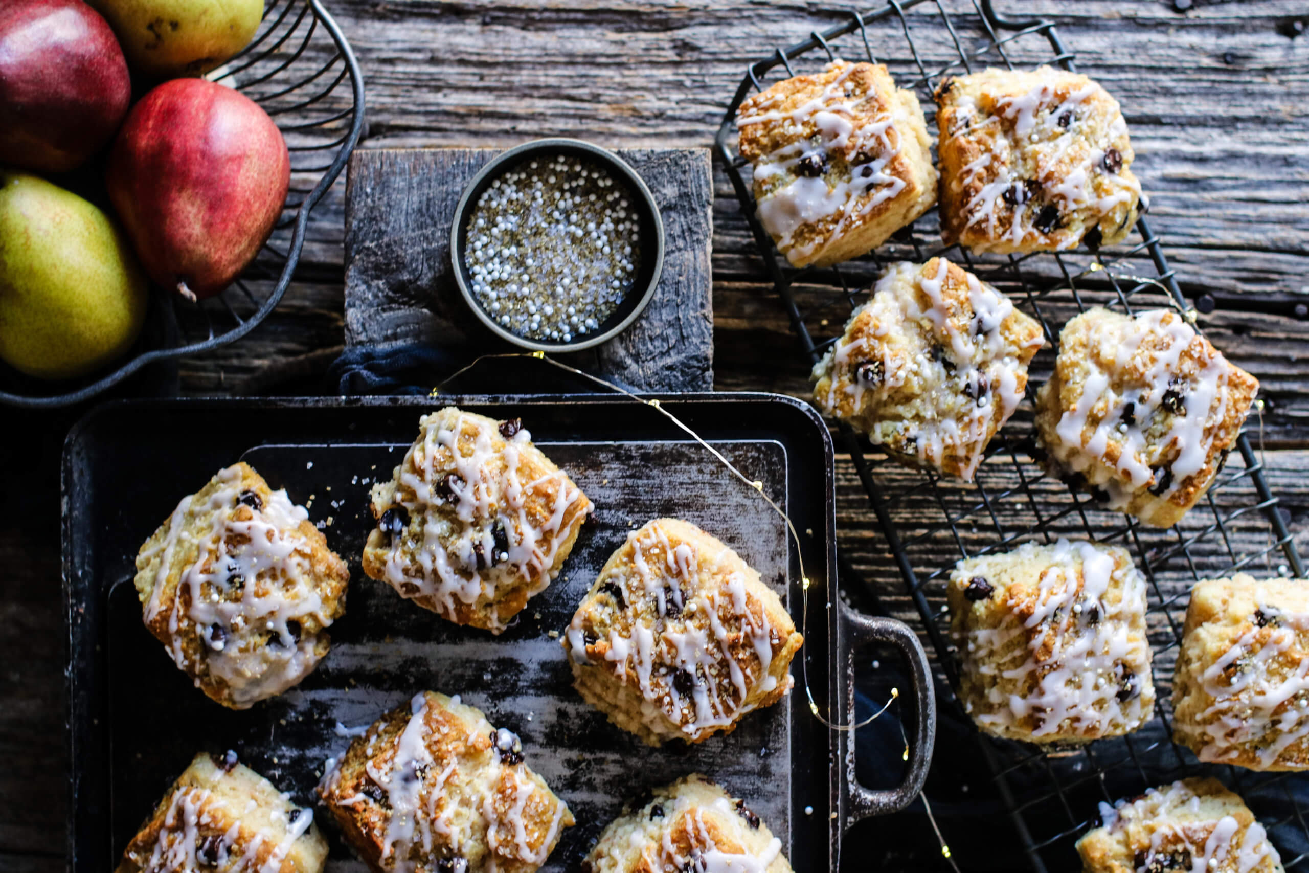 Dark Chocolate and Pear Scones on a drying rack with a fruit bowl in the background