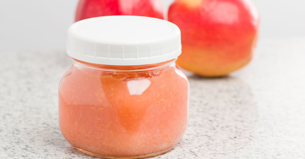 Pink Lady Apple sauce with apples in the background