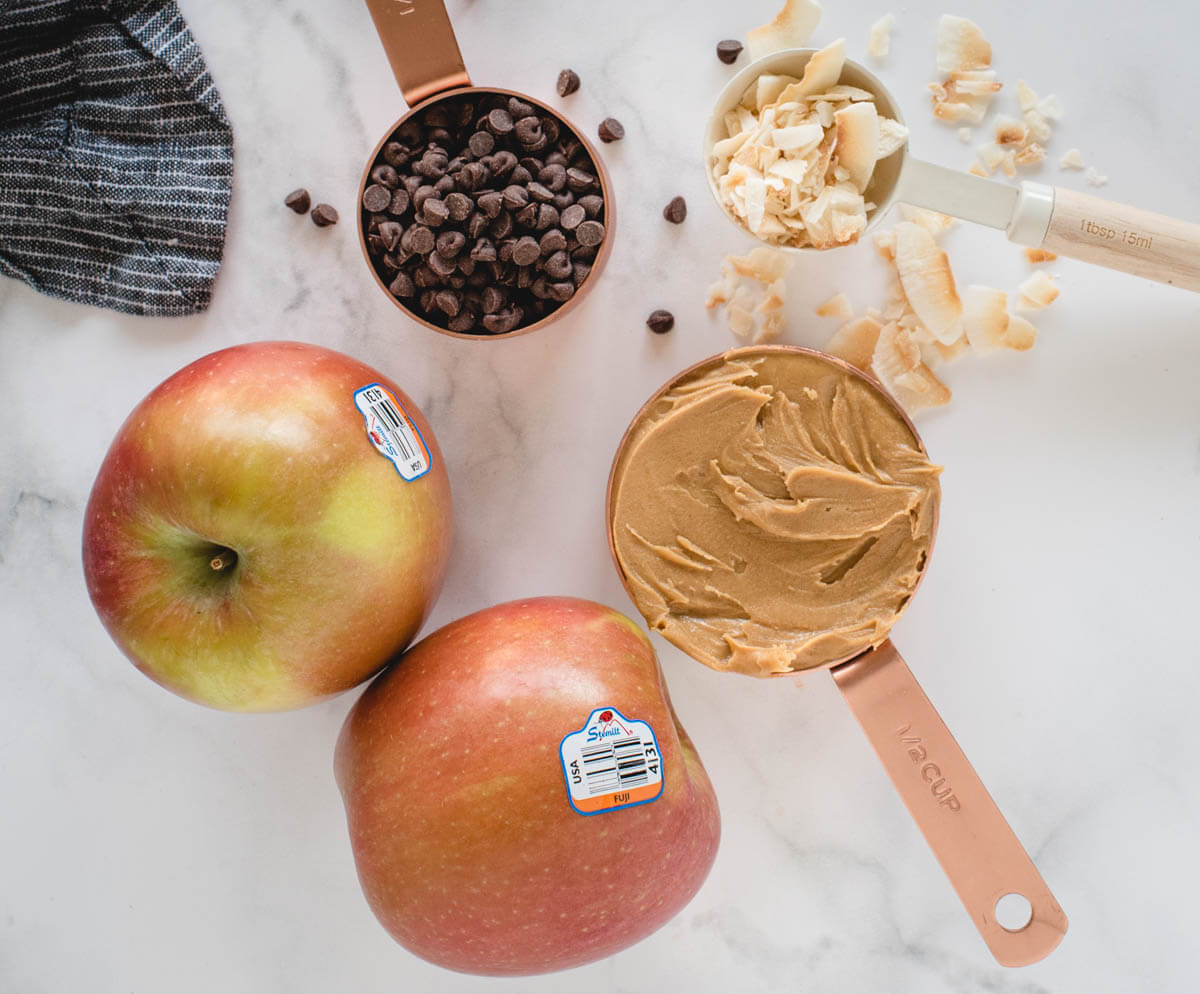 Peanut butter, chocolate chips, Stemilt Fuji Apples, and coconut flakes before becoming apple nachos