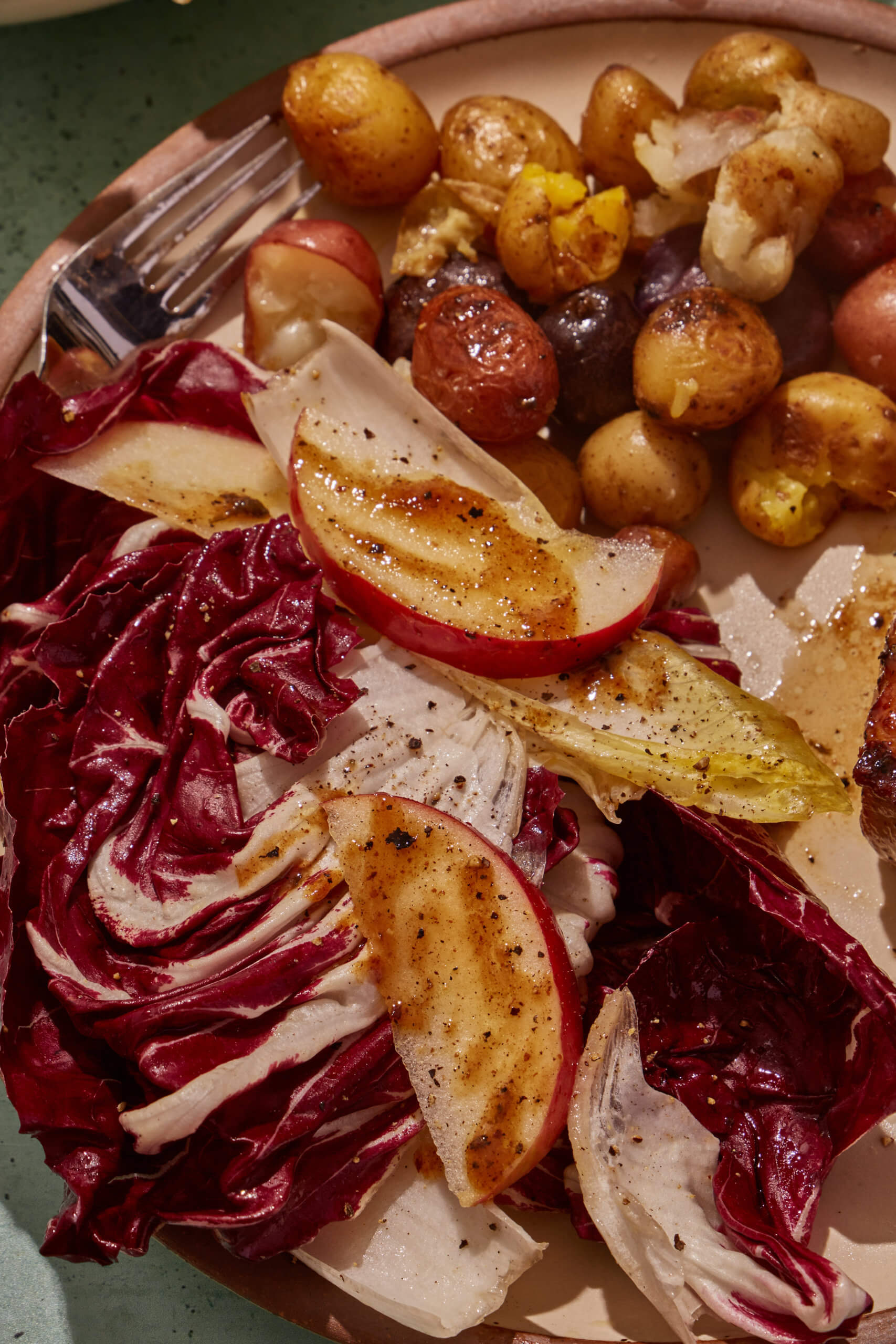 Apple cider vinaigrette on potatoes and a salad with apples.