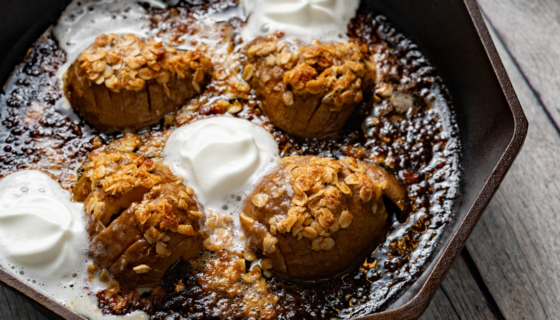 Hasselback Pears in a cast iron skillet with whipped cream