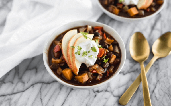 A bowl of Apple & Sweet Potato Chili topped with apple slices