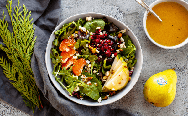 A winter pear salad with pomegranates, mandarin oranges, and pistachios 