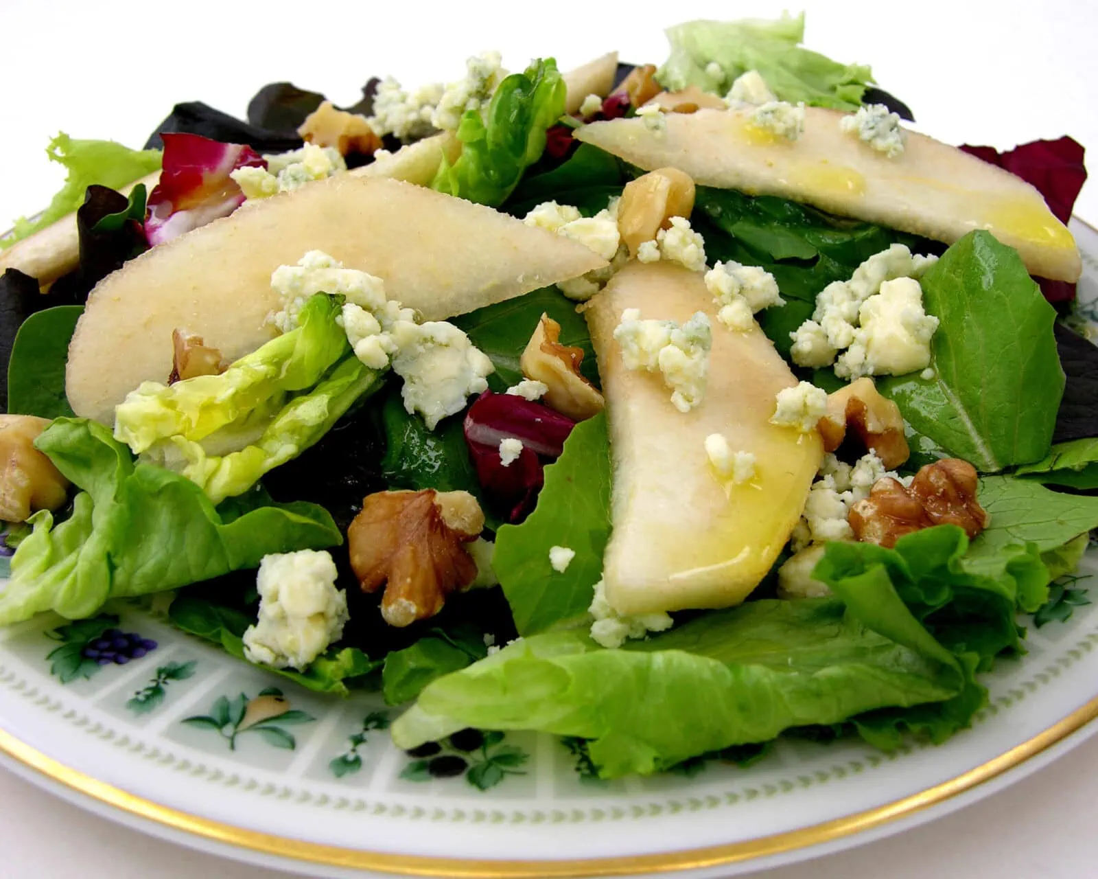 Fresh mixed greens salad with pears, walnuts, and blue cheese crumbles.