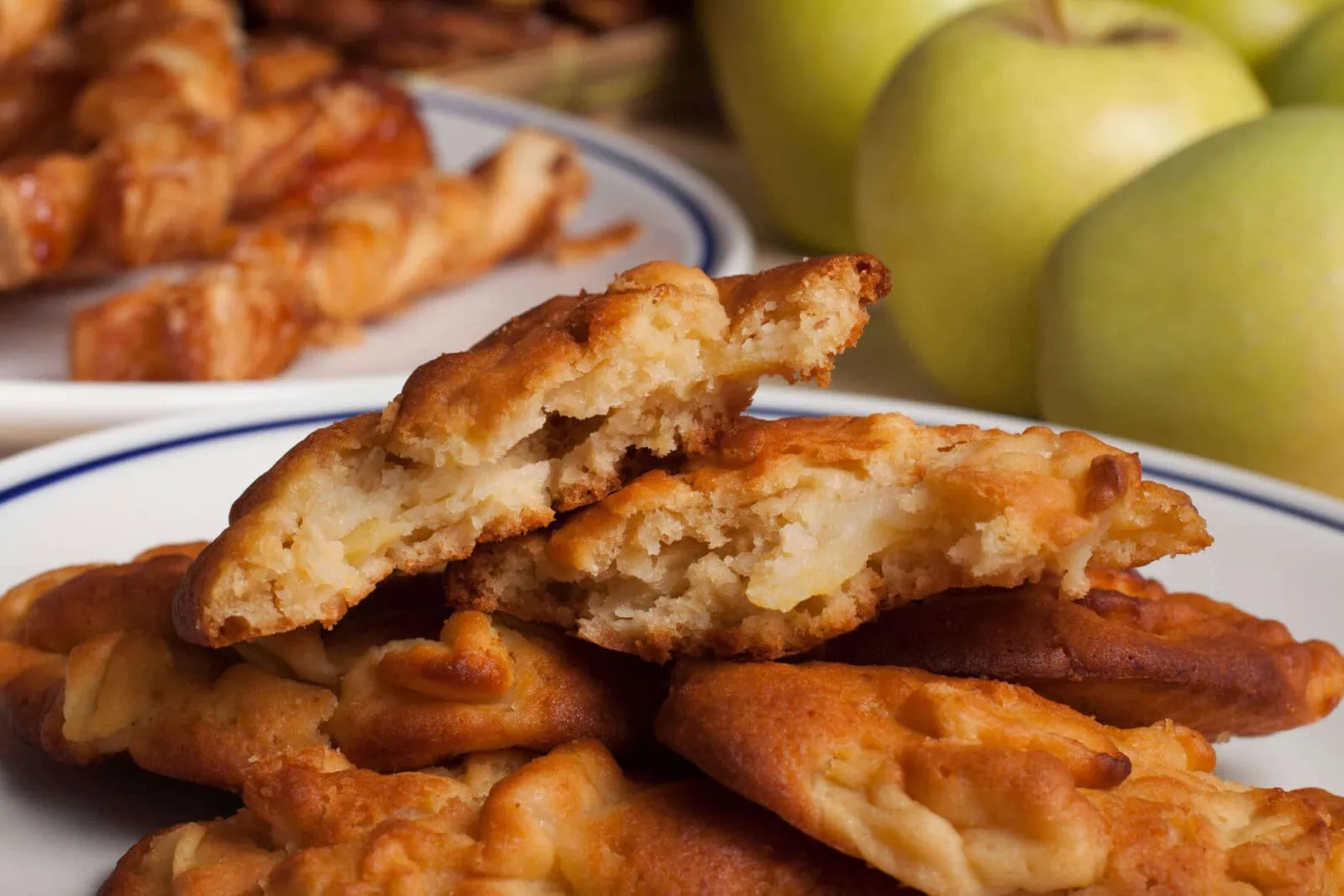 Close-up of apple fritters with a crispy golden exterior and apple filling.