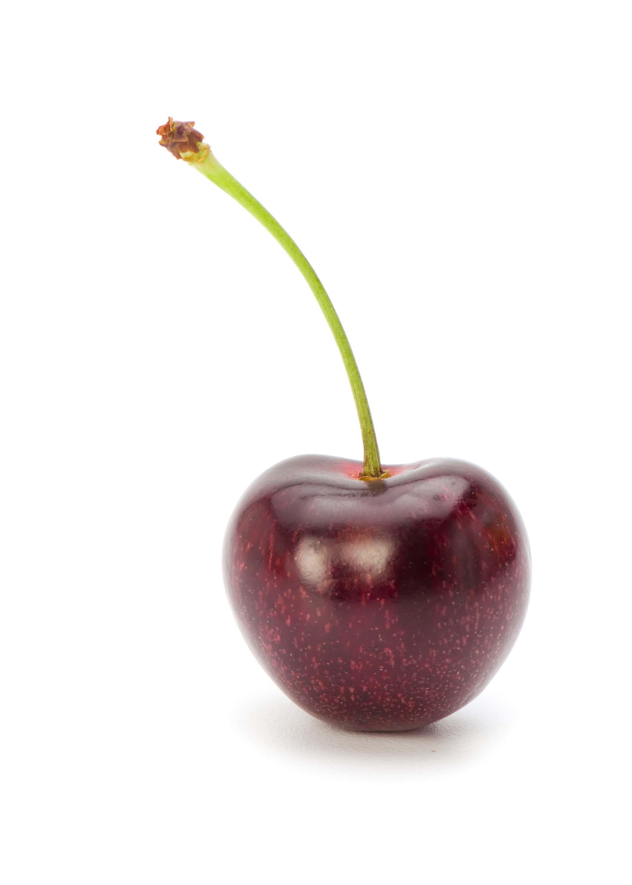 Fresh dark red cherry with stem on a white background.