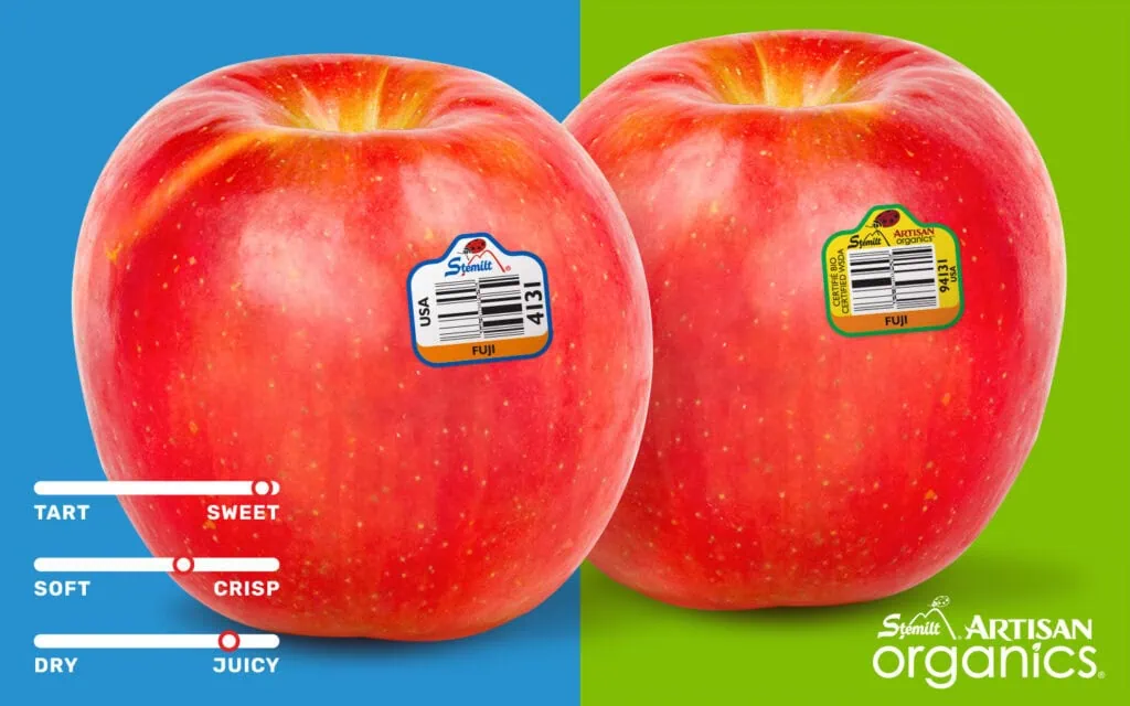 Two ripe Fuji apples with stickers on a split background.