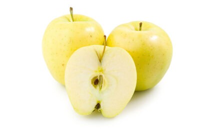 Fresh Golden Delicious apples with one cut in half showing interior.