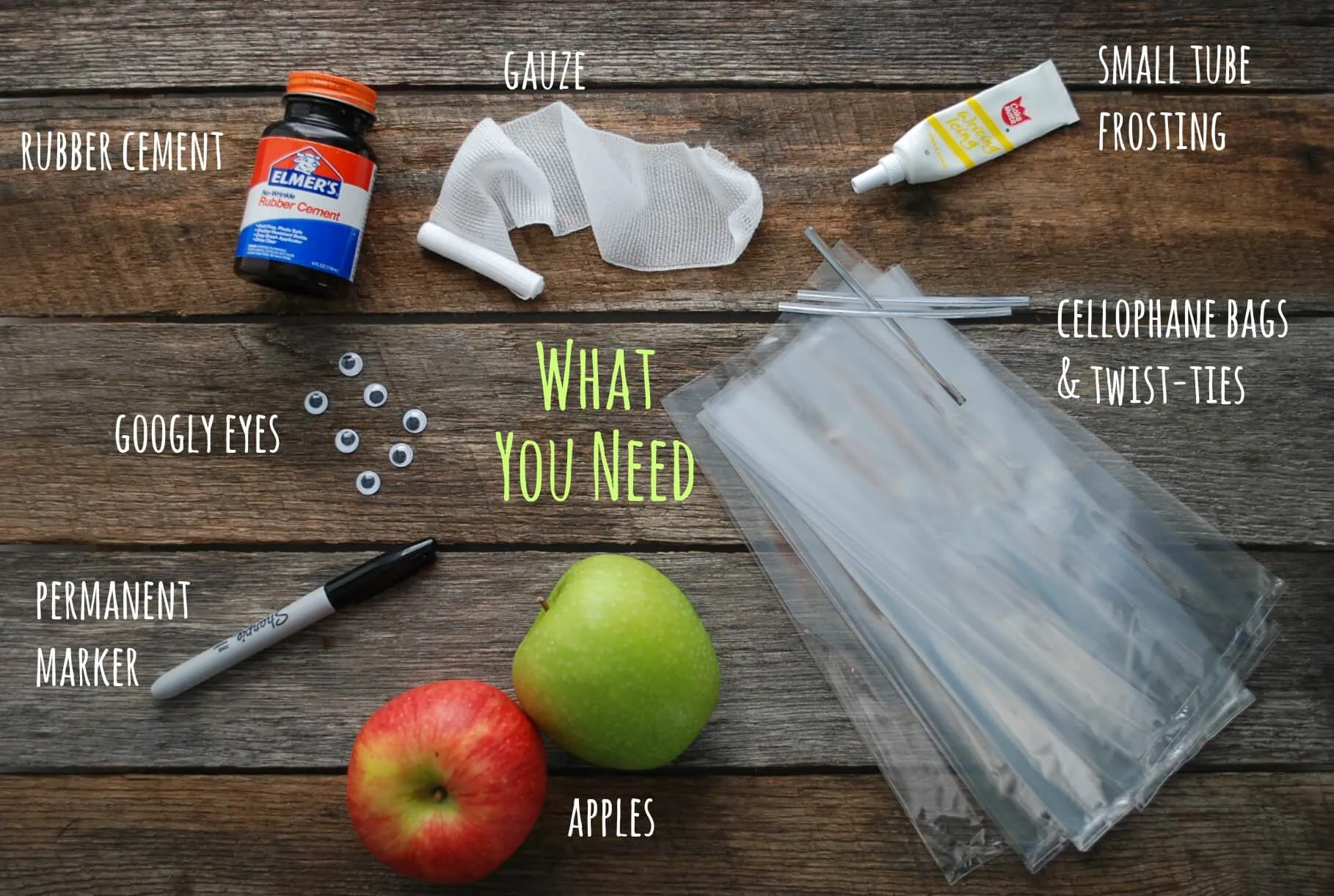 Apple favors supplies including apples, cellophane bags, and decorating tools.