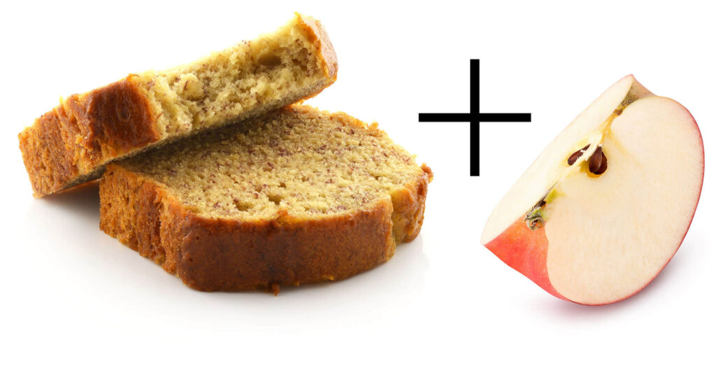 Banana bread slice with a fresh apple half for healthy snacking.