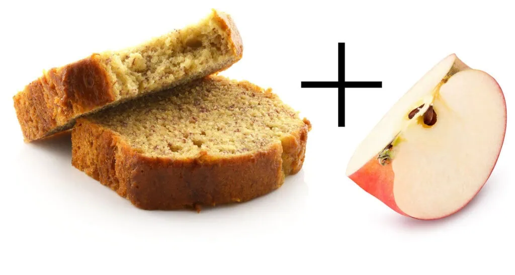 Banana bread slice with a fresh apple half for healthy snacking.