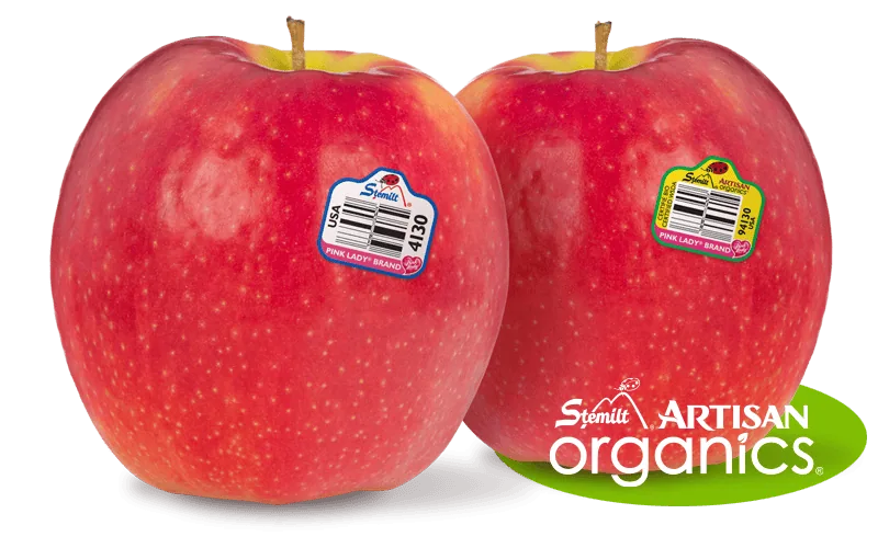 Two fresh organic apples with Stemilt Artisan Organics labels on a white background.